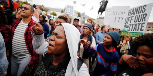 Demonstrators protest against South African President Jacob Zuma's firing of Finance Minister Pravin Gordhan, outside Parliament in Cape Town, South Africa, March 31, 2017.