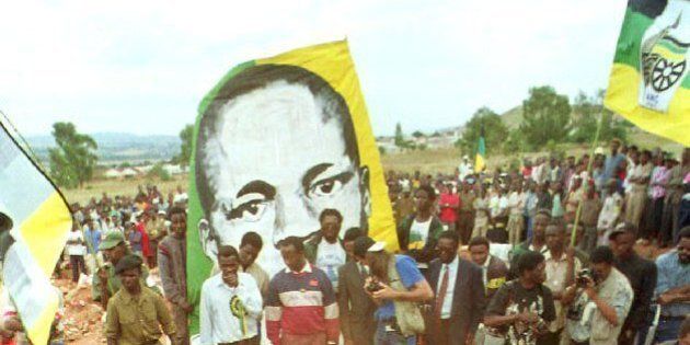 African National Congress marshalls fill in the grave of ANC comrade Solomon Mahlangu at a memorial in 1993.