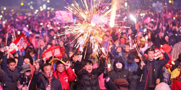 Protesters light fireworks as they celebrate the impeachment of South Korea's ousted leader Park Geun-hye at a rally in Seoul, South Korea, on 11 March, 2017.