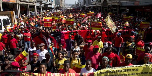 Supporters of the Congress of South African Trade Unions (COSATU) and the South African Communist Party (SACP) lead a march calling for the abolition of labour brokers and the implementation of a national health insurance scheme through Durban, South Africa, April 23, 2016.