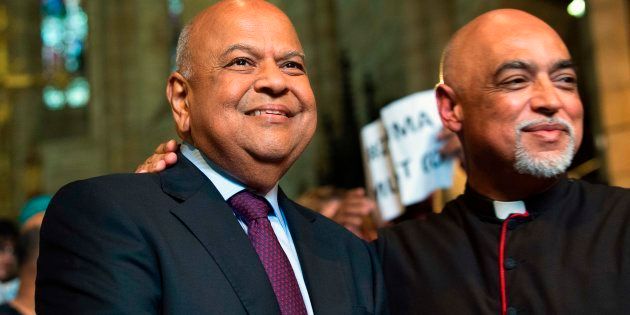 Pravin Gordhan, (L) the recently dismissed South African Minister of Finance, stands next to Reverend Michael Wheeder (R) at a memorial service for recently deceased anti-apartheid activist Ahmed Kathrada at St George's Cathedral in Cape Town on April 6, 2017.