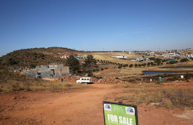 A "For Sale" sign is seen in front of vacant land and a house under constrution in an upmarket estate, south of Johannesburg, South Africa, July 21,2016.Reuters/Siphiwe Sibeko