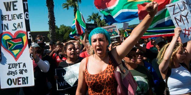Thousands of people protest outside the South African Parliament, waving South African flags and banners, to call for South African president to step down on April 7, 2017, in Cape Town.