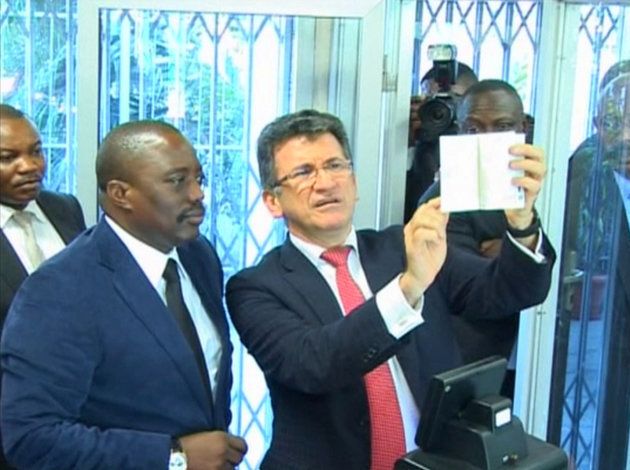 President Joseph Kabila of the Democratic Republic of Congo (L) is seen alongside Semlex CEO Albert Karaziwan during an event to launch the country's new biometric passports at the foreign ministry in Kinshasa in this still image taken from footage shot in November 2015 and made available to Reuters March 19, 2017.
