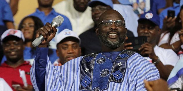 George Weah, former soccer player and presidential candidate of the Congress for Democratic Change (CDC), reacts while giving a speech during the party's presidential campaign rally at Samuel Kanyon Doe Sports Complex in Monrovia, Liberia.