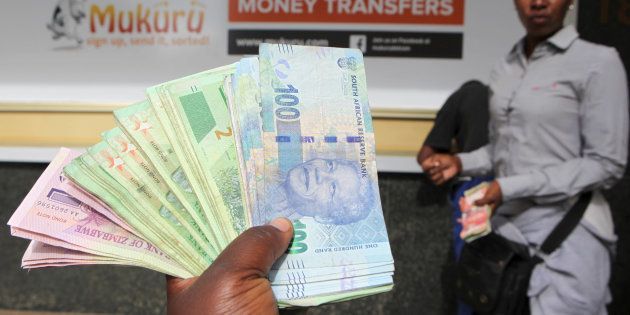 An forex dealer offers bond notes and South African Rand outside a bank in the central business district in Harare, Zimbabwe, February 24, 2017.