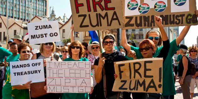 Protestors hold up placards reading 'Fire Zuma' during a demonstration of supporters of the Save South Africa (SaveSA) campaign, civil society organisations and political parties demanding South African President Jacob Zuma to resign on April 4, 2017 in Port Elizabeth.
