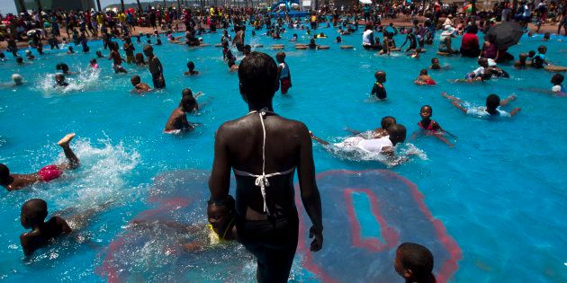 People swim in public pools among thousands taking to the beaches on New Year's Day in Durban on January 1, 2014. REUTERS/Rogan Ward