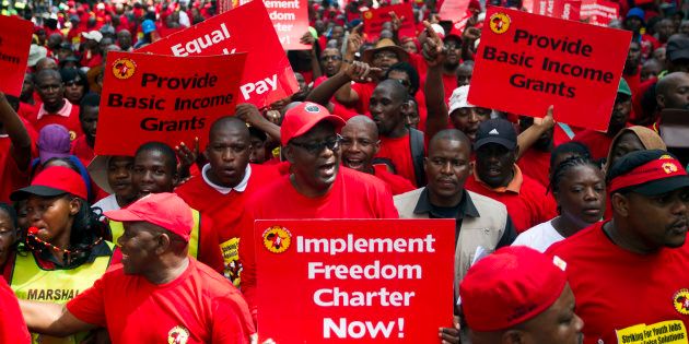 Suspended general secretary of the Congress of South African Trade Unions (Cosatu) Zwelinzima Vavi (C) protests with members of the National Union of Metal Workers of South Africa (Numsa) as they march through Durban on March 19, 2014, protesting against youth unemployment.