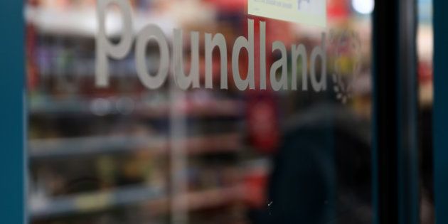 A Poundland logo sits at an entrance to a Poundland Group Ltd. discount retail store, operated by Steinhoff International Holdings.