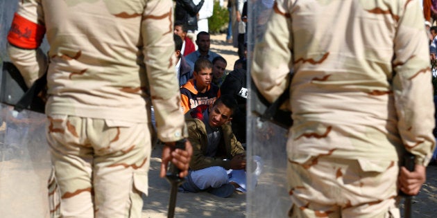 Military officers secure worshippers outside Al Rawdah mosque during the first Friday prayer after the attack in Bir Al-Abed, Egypt, December 1, 2017.