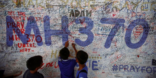 Children write messages of hope for passengers of missing Malaysia Airlines Flight MH370 at Kuala Lumpur International Airport.