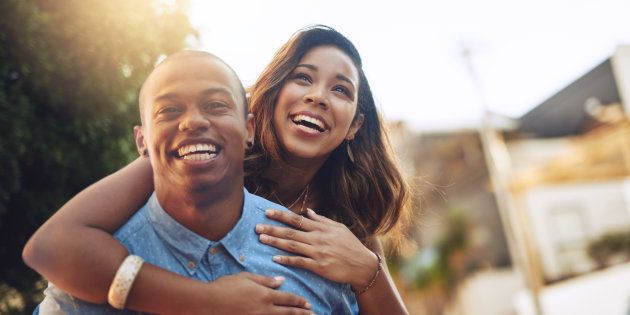 Shot of a happy young couple enjoying a piggyback ride outdoors