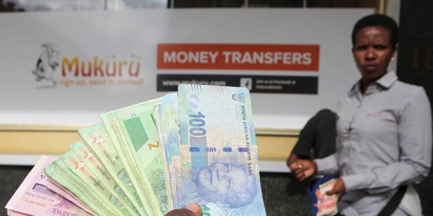 An forex dealer offers bond notes and South African Rand outside a bank in the central business district in Harare, Zimbabwe, February 24, 2017.