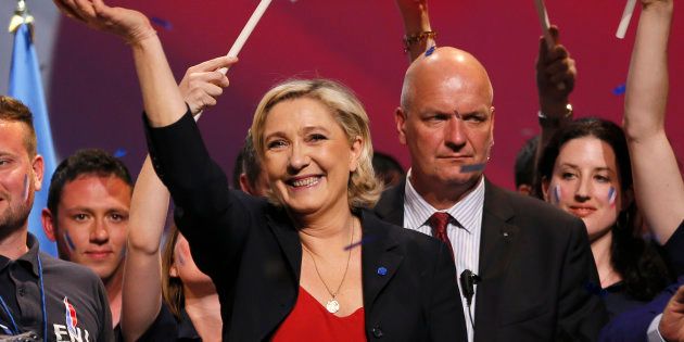 Marine Le Pen, French National Front (FN) political party leader and candidate for the French 2017 presidential election, attends a campaign rally as her bodyguard Thierry Legier (R) stands near in Marseille, France, April 19, 2017. REUTERS/Robert Pratta