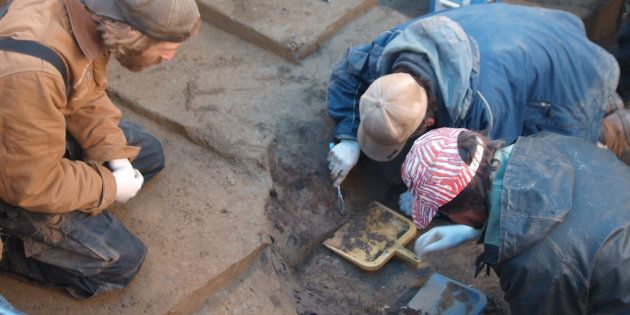 Members of the excavation team Joshua Reuther, Ben Potter and Joel Irish excavate the burial pit at the Upward Sun River site in central Alaska.