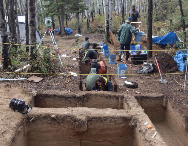 Members of the excavation team work in a trench connecting both areas of the Upward Sun River site in central Alaska.