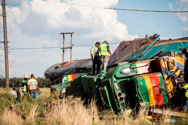 Passenger Rail Agency South Africa (PRASA) inspectors look at a derailed train locomotive after an accident near Kroonstad in the Free State Province.