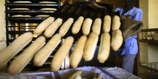 A Sudanese man works at a bakery in the capital Khartoum on January 5, 2018.Angry Sudanese queued outside bakeries in Khartoum as bread prices doubled overnight, with bakers blaming a government decision to stop importing wheat.