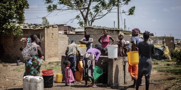 People collect water at a water point in the 'compound' township on the oustkirts of Lusaka on November 12, 2014, a day after the burial of the late Zambian president.