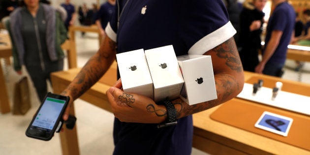 An Apple Store staff shows Apple's new iPhones X after they go on sale at the Apple Store in Regents Street, London, Britain, November 3, 2017.