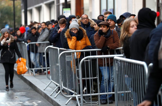 Customers queue outside the Apple Store in Regents Street before it opens on the day that the new iPhone X goes on sale in London, Britain, November 3, 2017.