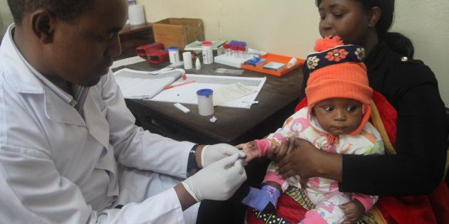 A doctor tests a child for malaria at the Ithani-Asheri Hospital in Arusha, Tanzania, May 11, 2016.