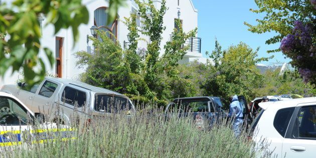 Police forensic investigators at De Zalze Golf Estate where three family members were hacked to death.