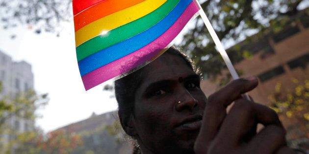 A participant holds a rainbow flag during