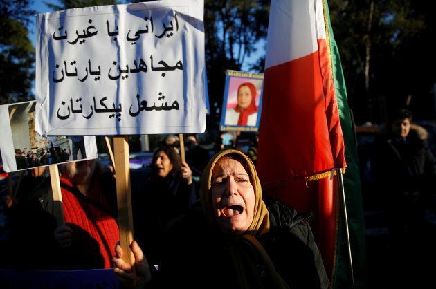 Opponents of Iranian President Hassan Rouhani hold a protest outside the Iranian embassy in Rome, Italy, January 2, 2018. The placard says: "Brave Iranian! Mujahideen is your friend! Fire will be your battle!"
