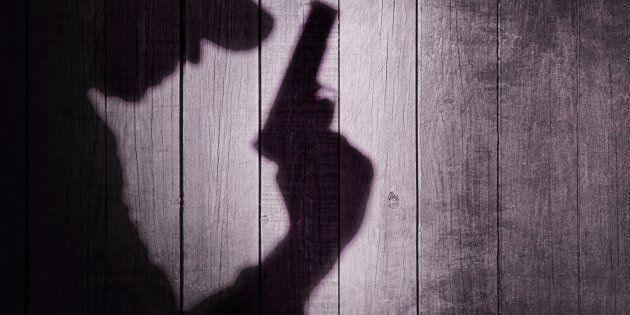 Gangster or investigator or spy silhouette on natural wooden wall. You can see more silhouettes and shadows on my page.