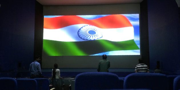 This picture taken on March 17, 2017 shows audience members standing for the Indian national anthem before a movie starts at the Regal cinema, an 84-year-old movie hall, in the heart of the Indian capital New Delhi.