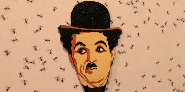 An image of Charlie Chaplin by Russian artist Vasily Slonov seen in the foreground, in Russia's Siberian city of Krasnoyarsk Museum Centre, October 25, 2012.