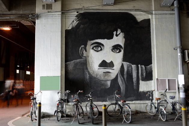 Osaka, Japan March 28, 2014: A picture of Charlie Chaplin on a wall of under elevated railway Nakatsu Station in Japan