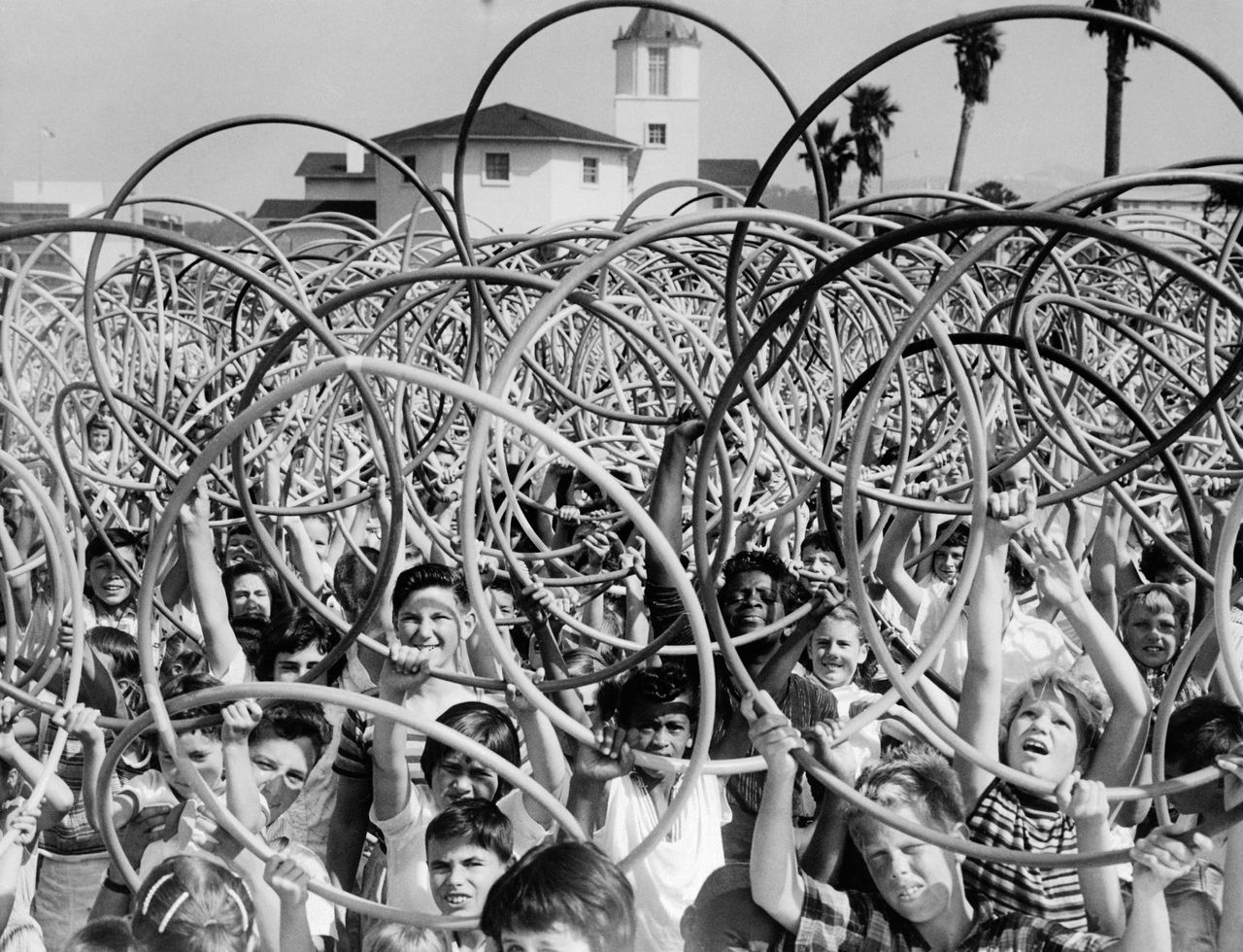 Kids hold up toy hoops in San Francisco circa 1958.