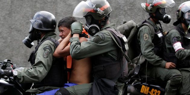 An opposition supporter is detained by riot police during a rally against Venezuela's President Nicolas Maduro in Caracas, Venezuela, April 26, 2017.