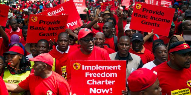 Suspended general secretary of the Congress of South African Trade Unions (COSATU) Zwelinzima Vavi (C) protests with members of the National Union of Metal Workers of South Africa (NUMSA) as they march through Durban, March 19, 2014. South Africa's largest union called for a one day strike on Wednesday to highlight youth unemployment in the country, where one in four people are jobless, the union said. The 340,000-member NUMSA draws its members from car manufacturing, the metal industry, transport and general workers. REUTERS/Rogan Ward (SOUTH AFRICA - Tags: BUSINESS EMPLOYMENT POLITICS CIVIL UNREST INDUSTRIAL)