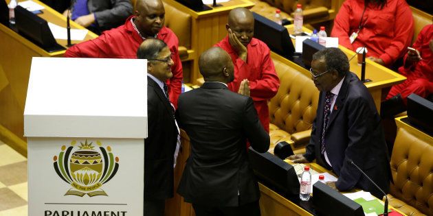 Opposition party leaders Mmusi Maimane (DA), Julius Malema (EFF) and Mangosuthu Buthelezi (IFP) confer shortly before voting during the motion of no confidence against President Jacob Zuma in Parliament.