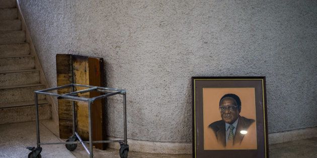 TOPSHOT - A picture taken on December 14, 2017 shows a portrait of former Zimbabwe President Robert Mugabe after it was removed from the hall during the 107th annual conference of the Zanu-PF Central Committee.