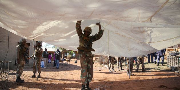 A member of the South African National Defence Force (SANDF) helps set up a tent to be used as a poling station during tense local municipal elections in Vuwani, South Africa's northern Limpopo province, August 3, 2016. REUTERS/Siphiwe Sibeko