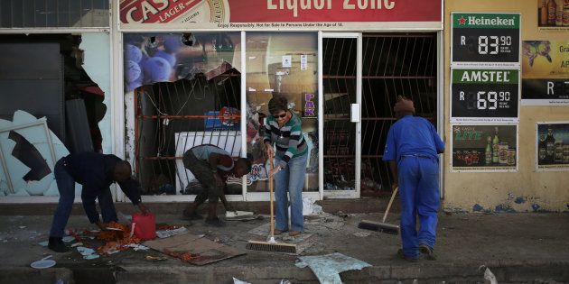 Locals clean up after over-night looting, when protesters took to the streets to demonstrate the killing of a boy in Coligny.