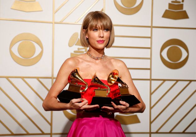 Singer Taylor Swift poses backstage with her awards for Best Music Video for "Bad Blood".
