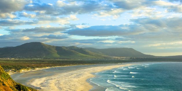 Scenic aerial view of Noordhoek Beach, Table Mountain National Park, South Africa at sunset. Noordhoek Beach, 8 km of sandy beach from Chapmans Peak Drive to Kommetjie and Slangkop Lighthouse.