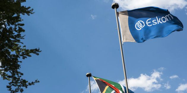 An Eskom flag flies alongside the South African national flag outside the state-owned utility's headquarters at Megawatt Park in Johannesburg, South Africa.