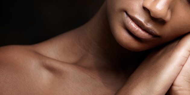 Cropped image of an african beauty with flawless skin sleeping against a black background