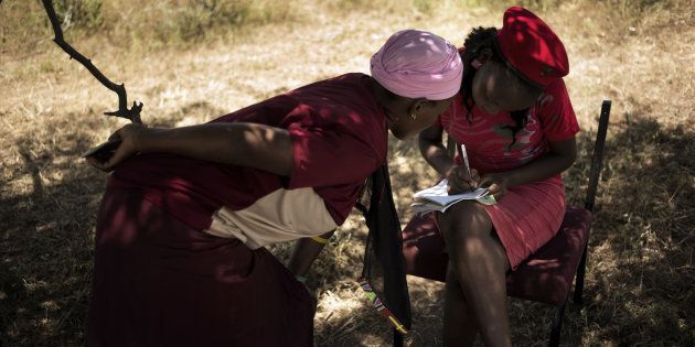 An Economic Freedom Fighters activist registers a woman outside a house newly built by the Economic Freedom Fighters leader and former ANC youth leader Julius Malema in Nkandla on January 22, 2014.