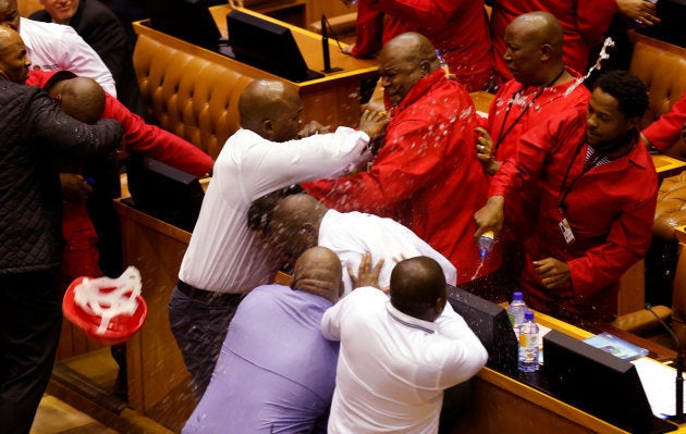 Party leader Julius Malema and members of his Economic Freedom Fighters (EFF) clash with Parliamentary security as they are evicted from the chamber in Cape Town, South Africa, May 17, 2016. REUTERS/Mike Hutchings