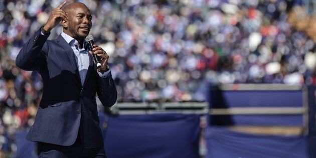 South African main opposition party Democratic Alliance leader Mmusi Maimane gestures as he gives his speech during the final Municipal Elections campaign rally at Dobsonville Stadium in Soweto, on July 30, 2016.