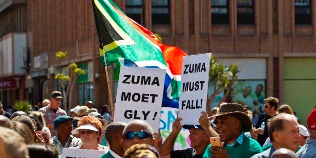 Protestors hold up placards reading 'Zuma must fall' during a demonstration of supporters of the Save South Africa (SaveSA) campaign.
