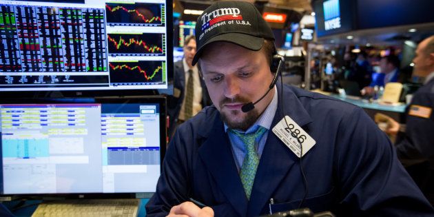 A trader wears a U.S. President Donald Trump hat while working on the floor of the New York Stock Exchange (NYSE) in New York, U.S., on Friday, March 10, 2017. U.S. stocks rose after jobs data cleared the way for the Federal Reserve to raise interest rates without forcing it to accelerate the pace for future tightening. Photographer: Michael Nagle/Bloomberg via Getty Images